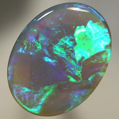 SOLID SEMI BLACK OPAL Large opal with rolling flashes of neon fire. SEE VIDEO